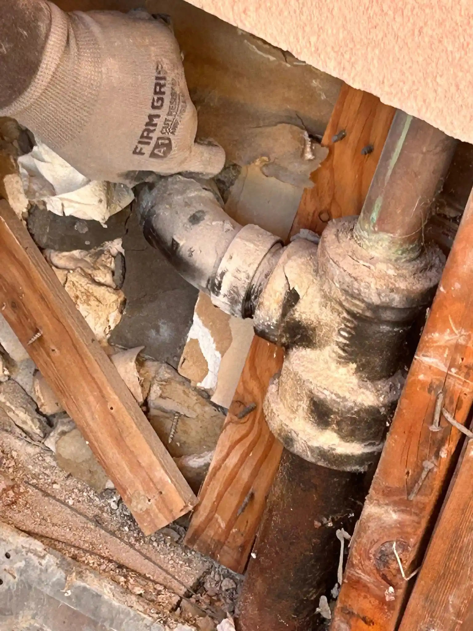 Corroded drain pipe being replaced in an older Chula Vista property