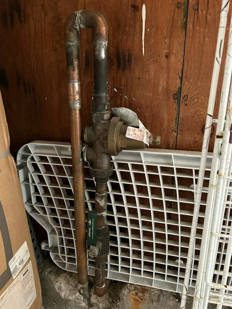 Corroded pipe exposed behind a wall in a Chula Vista property
