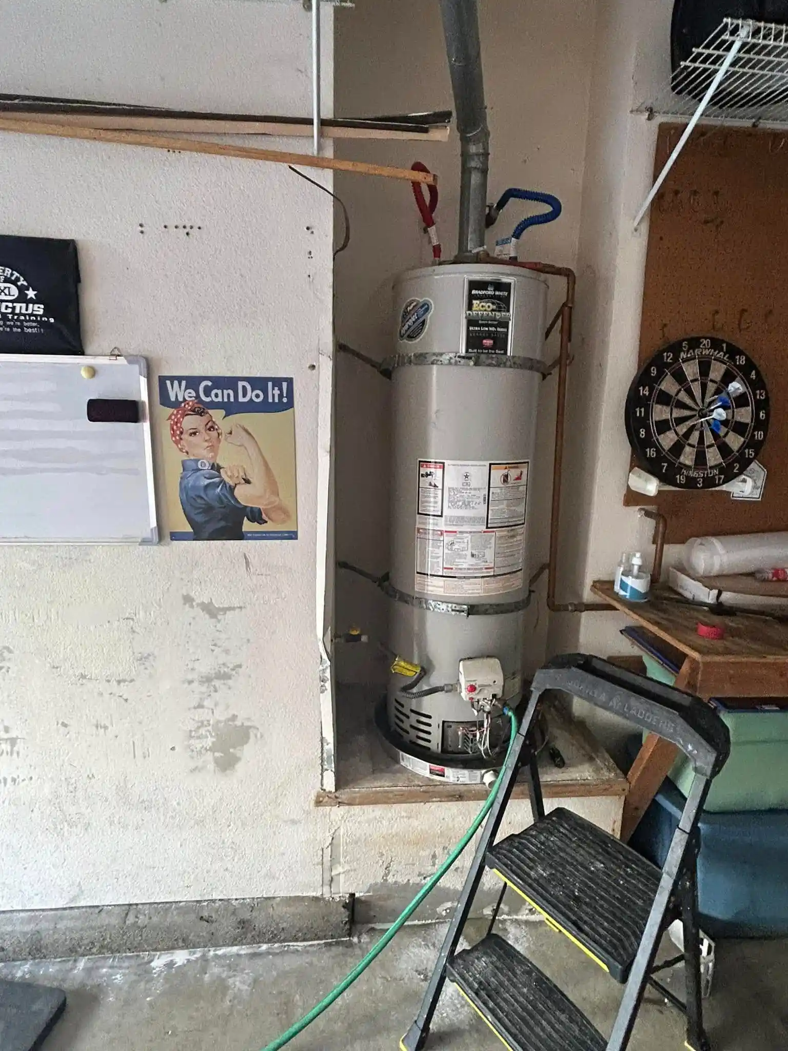 Gas water heater being serviced in a residential garage